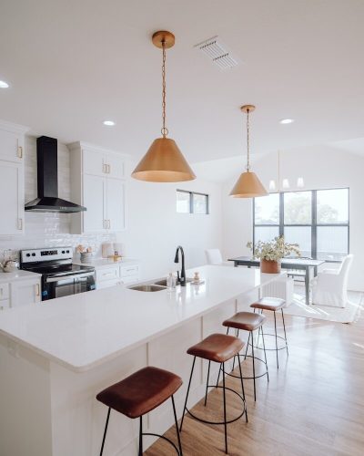 photo by bailey alexander a large kitchen with a center island and bar stools