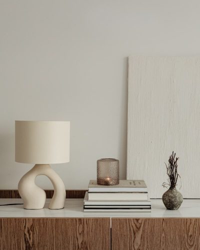 photo by karolina grabowska a lamp and books on a table